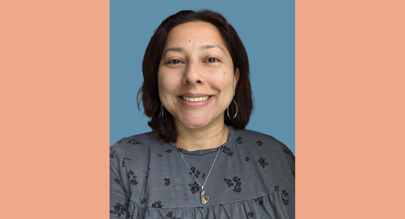 Portrait of article author Xatli Stox, smiling, with dark brown hair